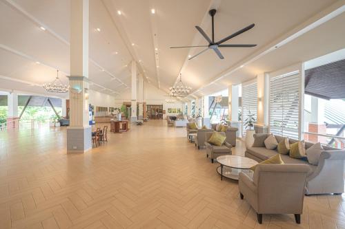 a lobby with couches and chairs in a building at Eco Hotel by Thammasat in Bang Lamung