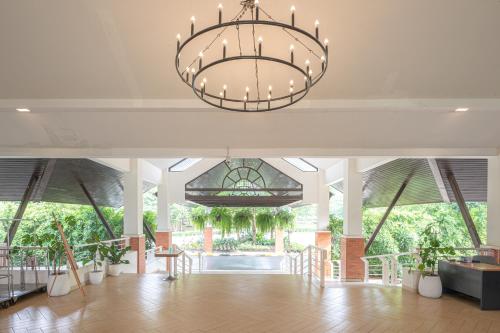 a large hall with a chandelier in a building at Eco Hotel by Thammasat in Bang Lamung