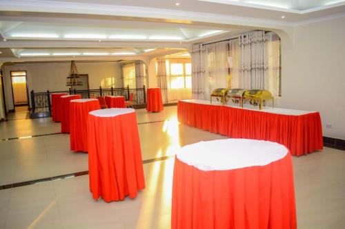 a room with red and white tables and yellow chairs at OLOIRIEN HOTEL & RESORT in Narok