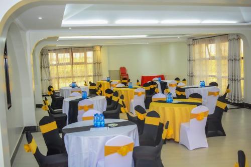 a room with yellow and white tables and chairs at OLOIRIEN HOTEL & RESORT in Narok