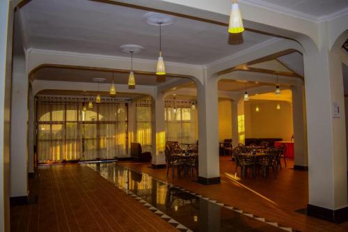 a hallway with tables and chairs in a building at OLOIRIEN HOTEL & RESORT in Narok