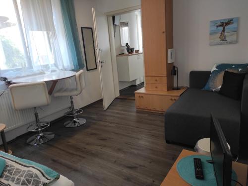 a living room with a couch and a table at Grossvaters Haus - Oba's Heisle in Lauingen