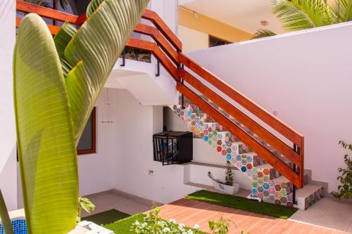 a spiral staircase in a house with plants at Villa PalMarina in Praia