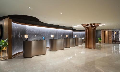 a lobby with a row of tables and a column at InterContinental Istanbul, an IHG Hotel in Istanbul