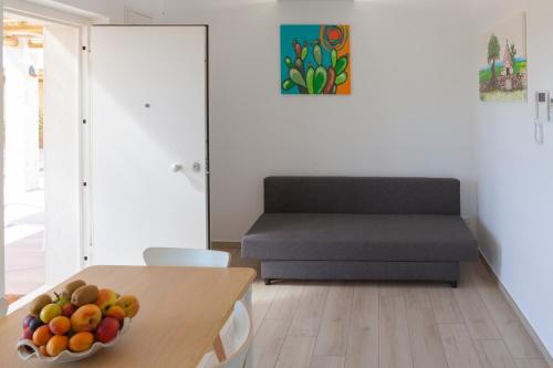 a room with a table with a bowl of fruit on it at Casa Valerio in Conversano