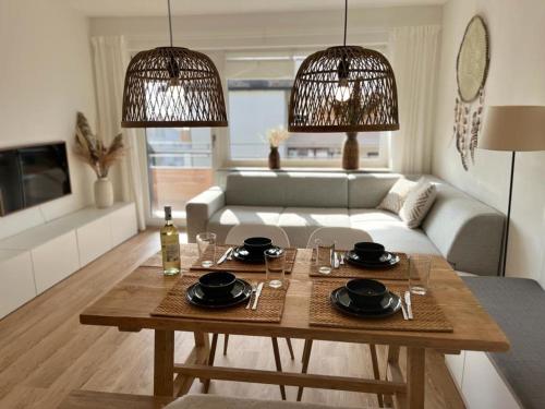 a living room with a table and a couch at Amselnest in Rimsting