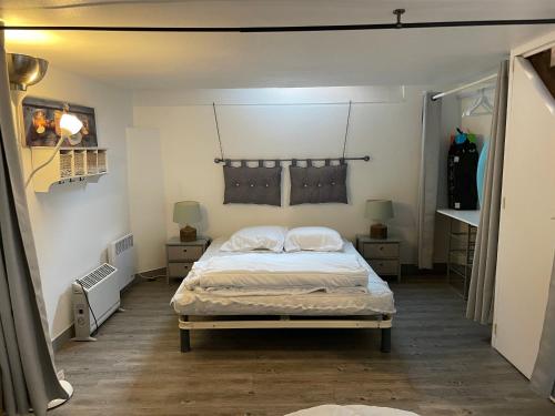 una camera con un letto e due comodini di SOUPLEX 50m de la plage et des commerces a Houlgate
