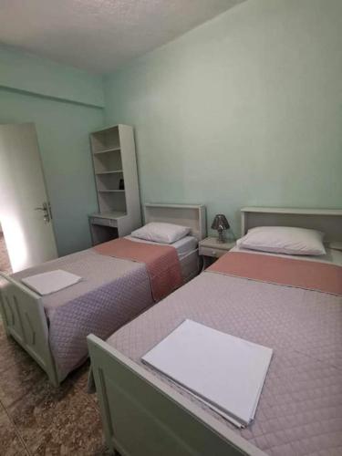 a room with two beds in a room at Vasilis House in Myrties