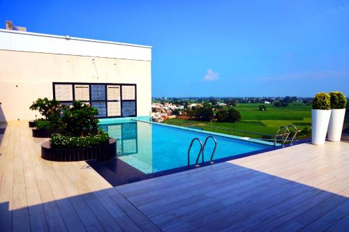 a swimming pool on the roof of a house at Mariton Hotel in Jalandhar