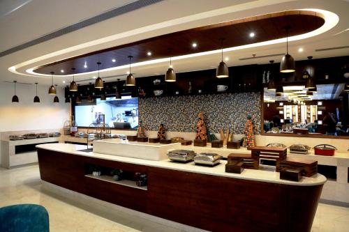 a large kitchen with a large counter in a restaurant at Mariton Hotel in Jalandhar