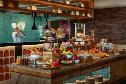 a buffet with many different types of food on display at Uday Palace Navsari, a member of Radisson Individuals in Navsāri