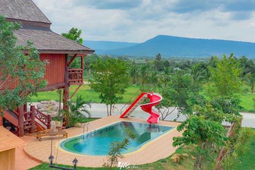 a pool with a red sculpture in front of a house at Tayama Farm Khaoyai in Nakhon Ratchasima