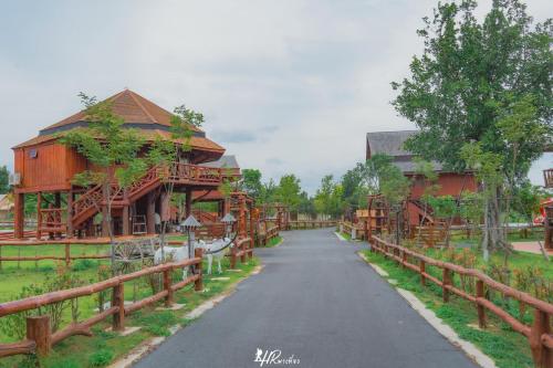 a road through a village with wooden buildings at Tayama Farm Khaoyai in Nakhon Ratchasima