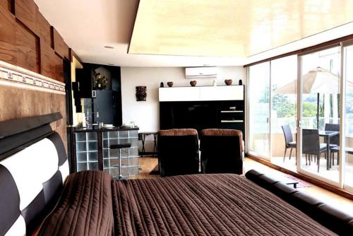 a living room with a bed and a dining room at Views from the Heart of theForest ,Wi-Fi, TV, Terrace in Mexico City