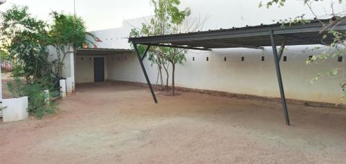 a building with a garage with a roof at Cytyz Appart Hôtel in Mahajanga