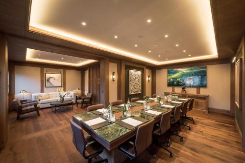 a conference room with a long table and chairs at Gstaad Palace in Gstaad