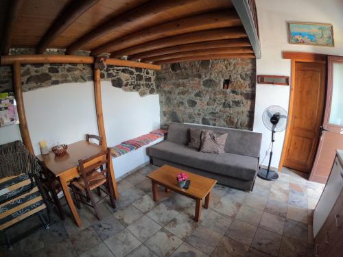 a living room with a couch and a table at AgroSpito Traditional Guest House in Agros