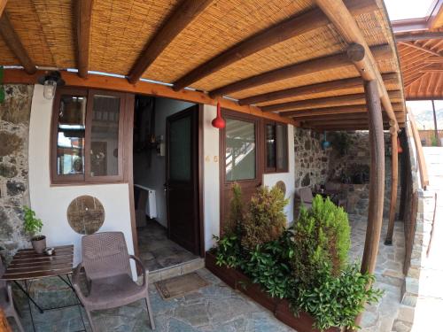 a patio with a wooden pergola at AgroSpito Traditional Guest House in Agros