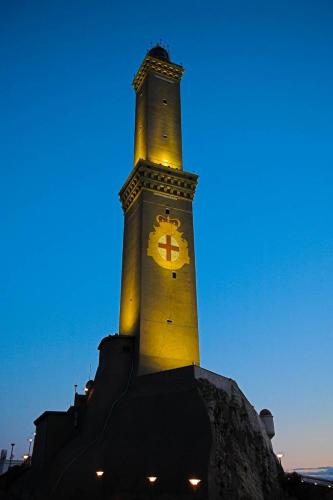a tall clock tower with a clock on it at CasaBolla in Genova