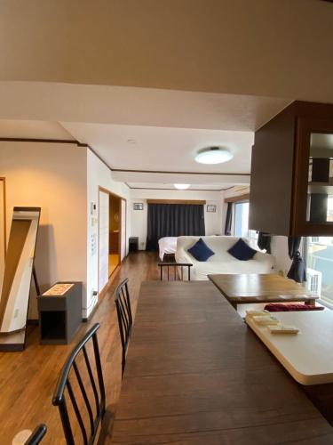 a kitchen and living room with a table and a bed at La Foret Fujimi in Hiroshima