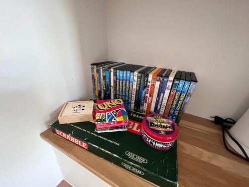 a pile of books sitting on a shelf at L’Aragne in Dinant