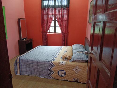 1 dormitorio con cama y ventana en Homestay Murah Umbai Melaka, en Merlimau