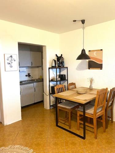 a kitchen and dining room with a table and chairs at Ferienwohnung Nr. 3 Rügen Zudar Kanu Kajak Bodden in Zudar