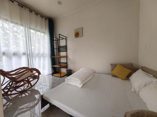 a living room with a white couch and a window at coral coast FIJI in Sigatoka