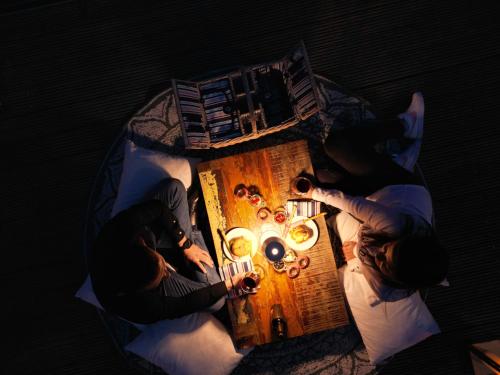 two people sitting at a table in the dark at Boutique Hotel Sunstar Brissago am Lago Maggiore in Brissago