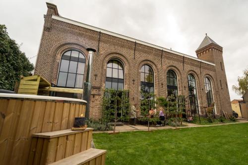 a brick building with people sitting outside of it at De Kerck - bijzonder overnachten in Middelburg