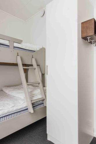 a room with two bunk beds and a mirror at Funäs Ski Lodge in Funäsdalen