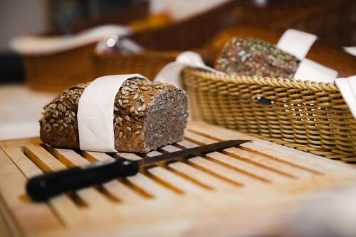 a loaf of bread and a knife on a table at JUFA Alpenhotel Saalbach-Jokercard im Sommer inklusive in Saalbach Hinterglemm