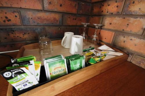 a wooden tray with food and drinks on a table at Golden Palms Motel in Geelong