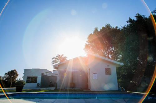 a reflection of a house with the sun in a mirror at Marilyn's Rooms in Swellendam
