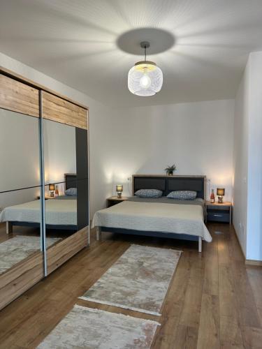 a bedroom with a bed and a chandelier at Regim hotelier - AP2camCentral in Craiova