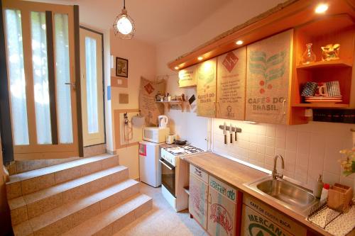 a small kitchen with a sink and a stove at Film Poster or Coffee Basement Apartman with terrace in Budapest