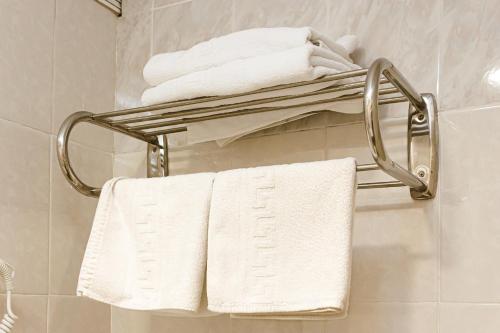 a towel rack in a bathroom with white towels at Pensión Úbeda in Fuenmayor