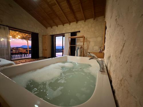 uma casa de banho com uma banheira cheia de água em Villa Luvia em Kas