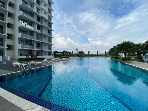 a large swimming pool in front of a building at The Platino By Antlerzone in Johor Bahru