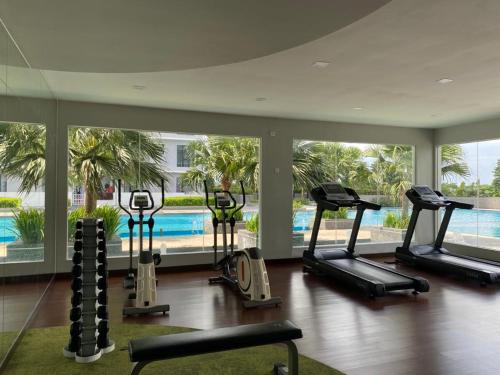 a gym with several treadmills and a swimming pool at The Platino By Antlerzone in Johor Bahru
