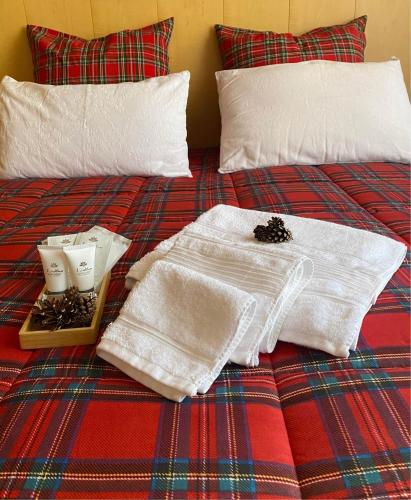 a bed with white towels and a tray of nuts at Casa Monte Zebio in Asiago