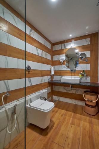 a bathroom with a toilet and a sink at The Scenic Unity in Garudeshwar