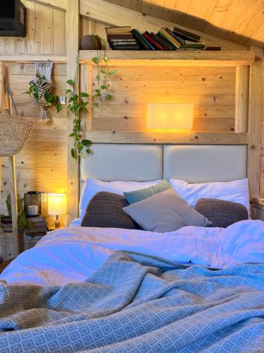 a large bed in a room with a wooden wall at Hotel Borjomi Verde in Borjomi