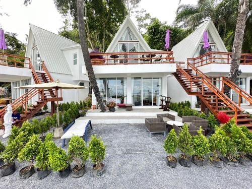 a house with a patio with a surfboard at 7 Heaven camping Lanta in Krabi