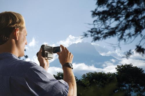 a man taking a picture of the sky with a camera at Dik Dik Hotel in Arusha