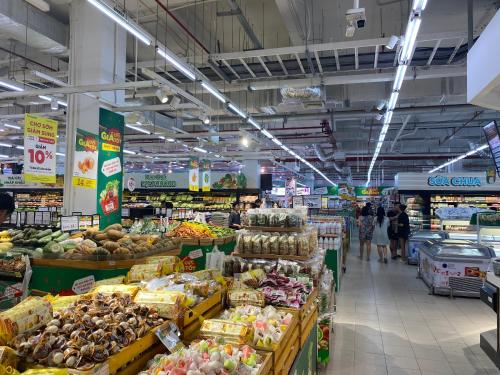 a grocery store aisle with fruits and vegetables at Housinco Premium - Serviced Apartments Nguyễn Xiển Street near Tops Market in Hanoi