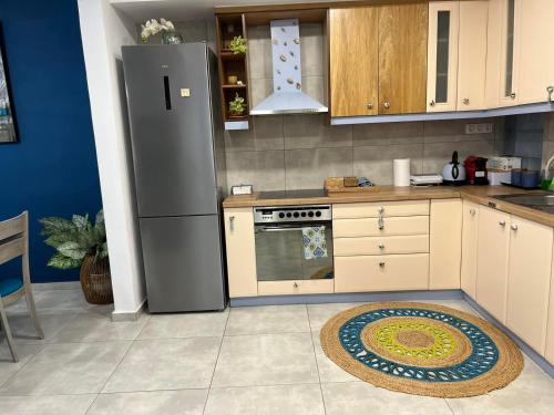 a kitchen with a refrigerator and a stove at Blue Siri Apartment in Heraklio