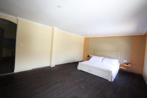 a bedroom with a white bed in a room at Villa Tizra - Guest house in AÃ¯n el Ksob