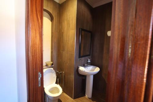 a bathroom with a toilet and a sink at Villa Tizra - Guest house in AÃ¯n el Ksob