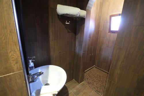 a bathroom with a sink and a toilet and a window at Villa Tizra - Guest house in AÃ¯n el Ksob